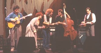 5 musicians on stage with guitars, mandolin and base